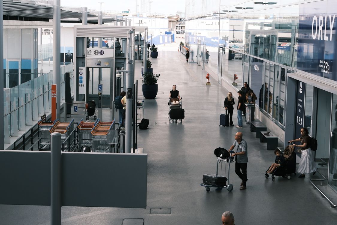 Busy airport terminal with travelers and luggage — health declaration checks could add to immigration wait times at Vietnamese airports during peak hours