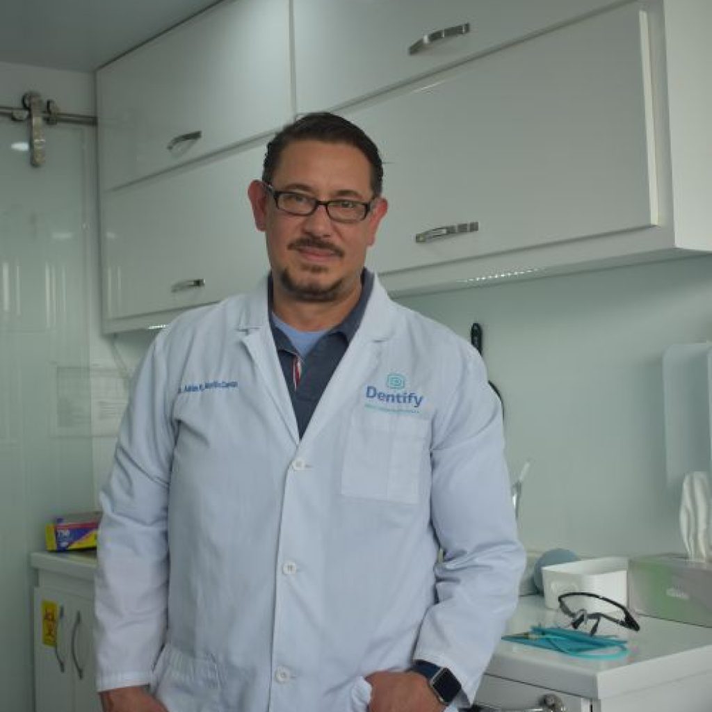 Clinic staff member beside dental equipment