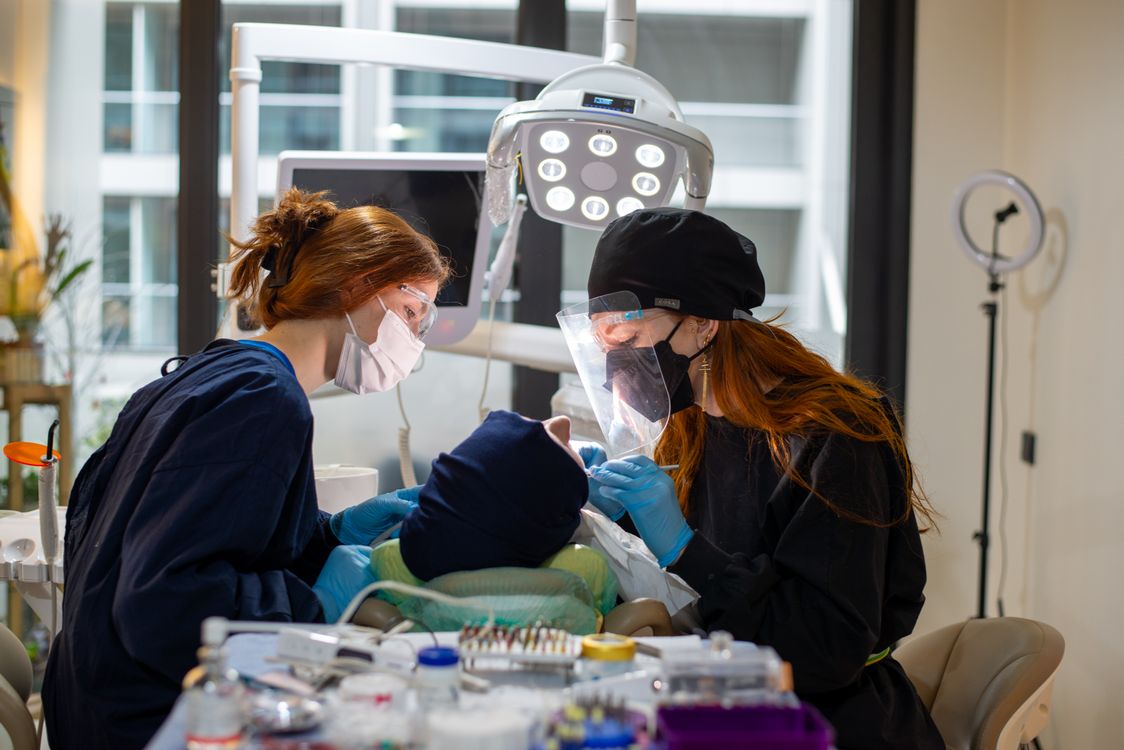 Dentists examining a patient at a modern Da Nang dental clinic — English-speaking professionals using advanced equipment.