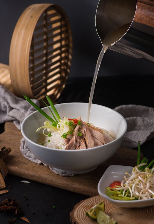 Authentic Pho Ga (chicken pho) served with rice noodles and fresh herbs in Hanoi