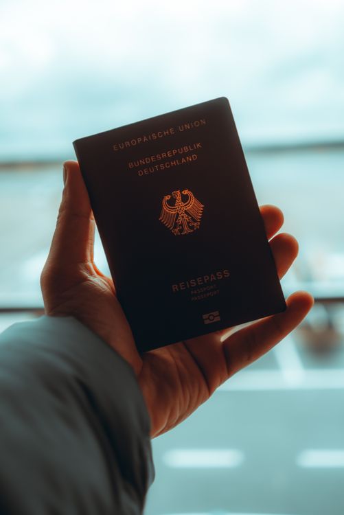 Close-up of a person holding a passport, representing travel document preparation for Vietnam