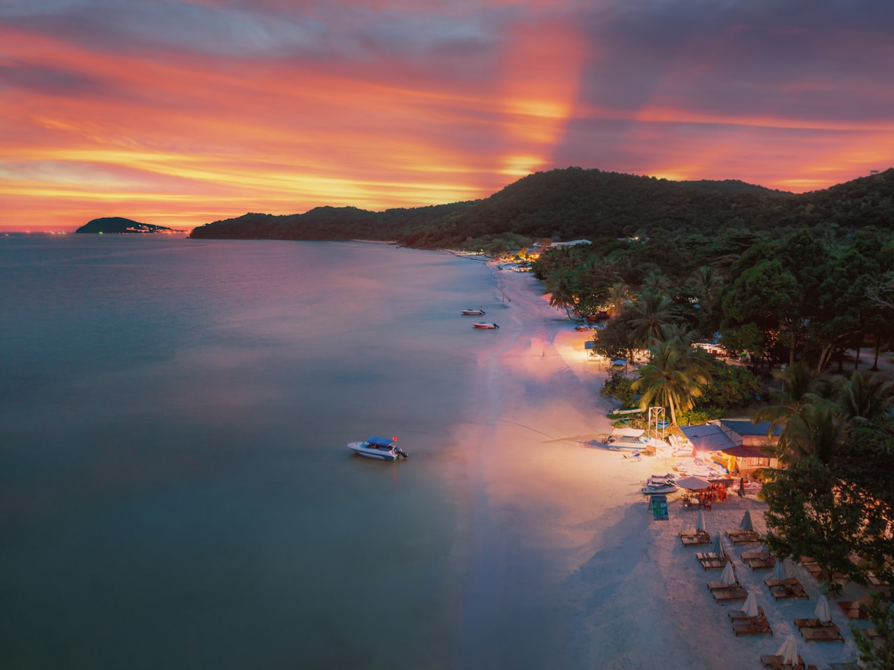 Sunset aerial view of Sao Beach Phu Quoc with boat in turquoise water