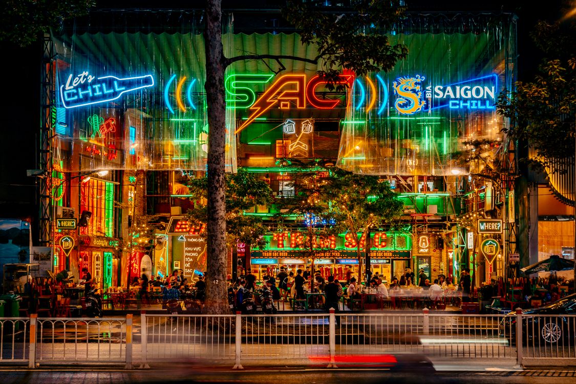 Neon-lit street market scene in Saigon at night