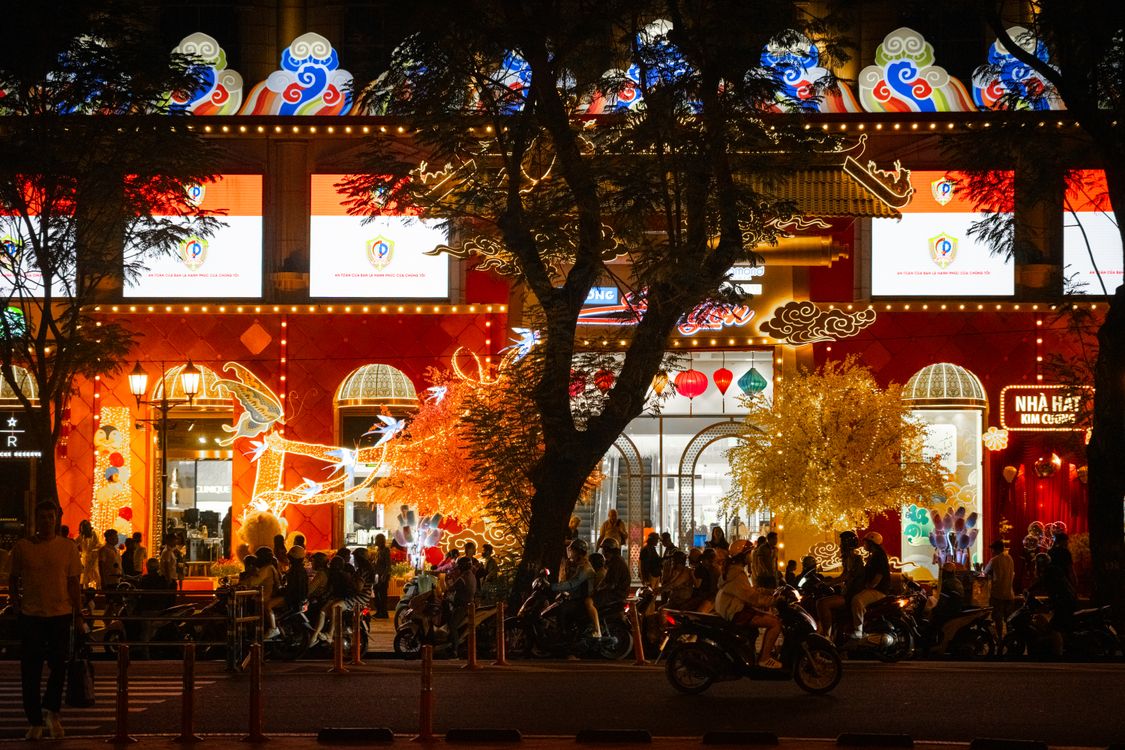 Nightlife street scene in Ho Chi Minh City with neon lights and crowds
