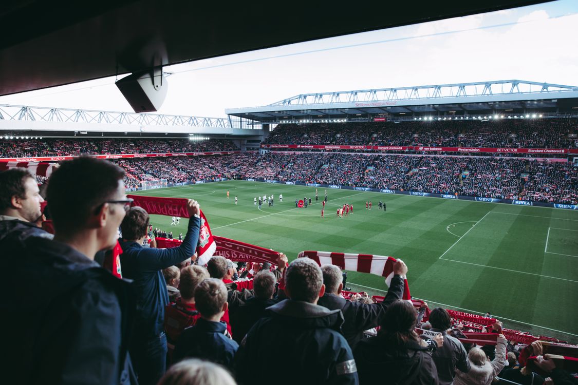 Crowd of football fans cheering at a sports bar