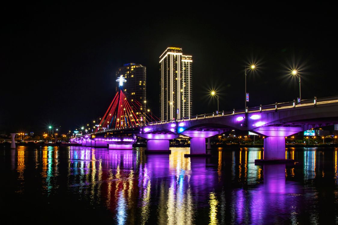 Da Nang's Dragon Bridge illuminated in red and yellow at night