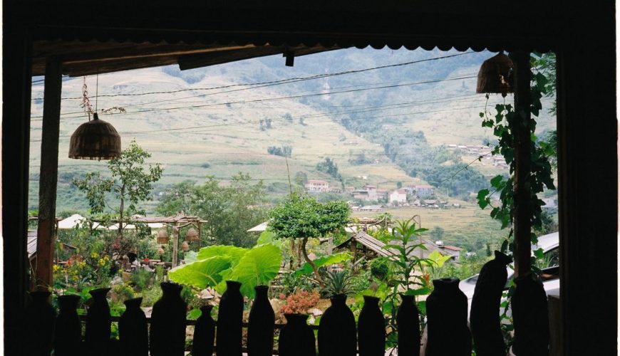 Lush green Sapa rice terraces in summer with misty mountains in the background