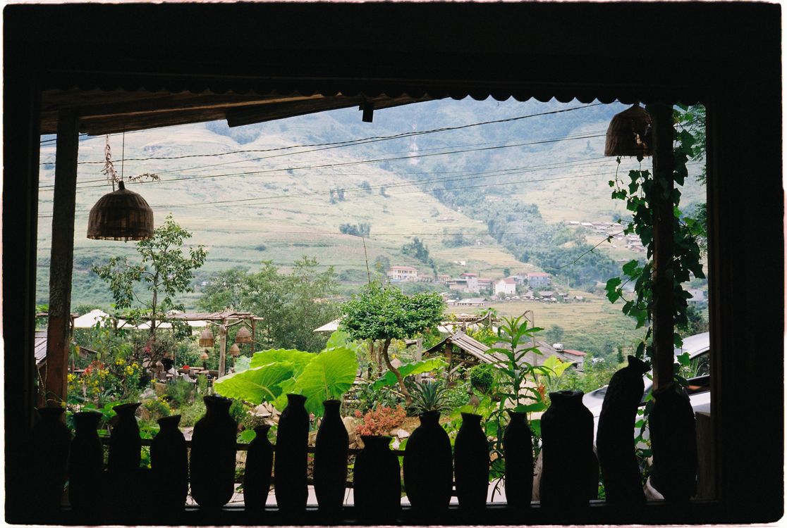 Lush green Sapa rice terraces in summer with misty mountains in the background