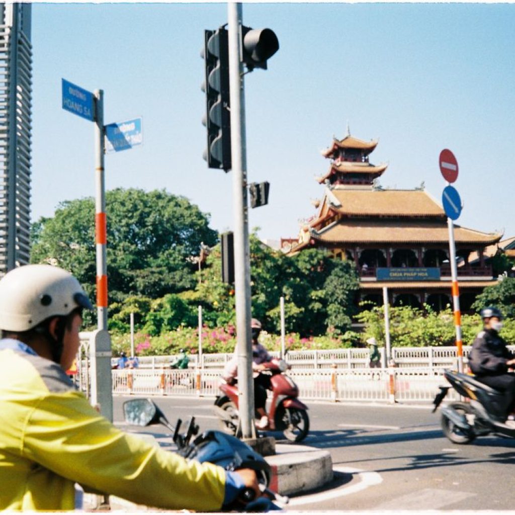 A busy street scene in Ho Chi Minh City, showing motorbikes and pedestrians — the energy of Vietnam travel in July