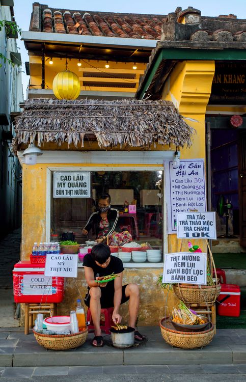 Street food vendor cooking at a night market in Hoi An, Vietnam