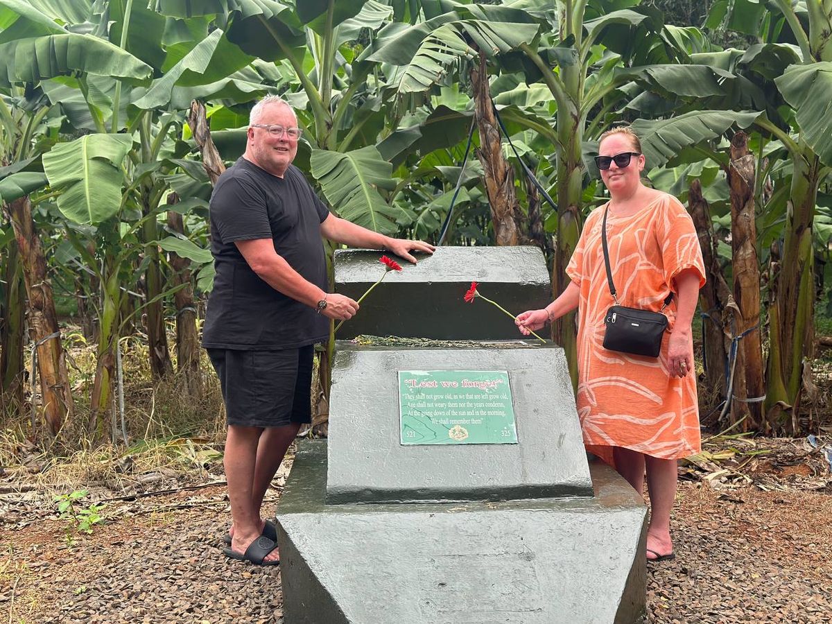 Long Tan memorial with inscription Lest We Forget, visited by Australian tourists