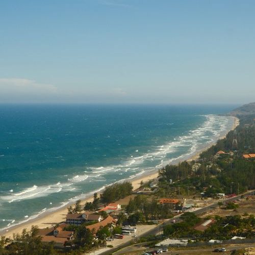 Aerial view of Mui Ne coastline with turquoise water and sandy beach in Vietnam