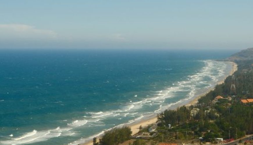 Aerial view of Mui Ne coastline with turquoise water and sandy beach in Vietnam