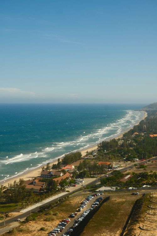 Aerial view of Mui Ne coastline with turquoise water and sandy beach in Vietnam