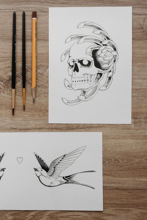 Tattoo design sketches on paper showing custom artwork options at Da Nang shops