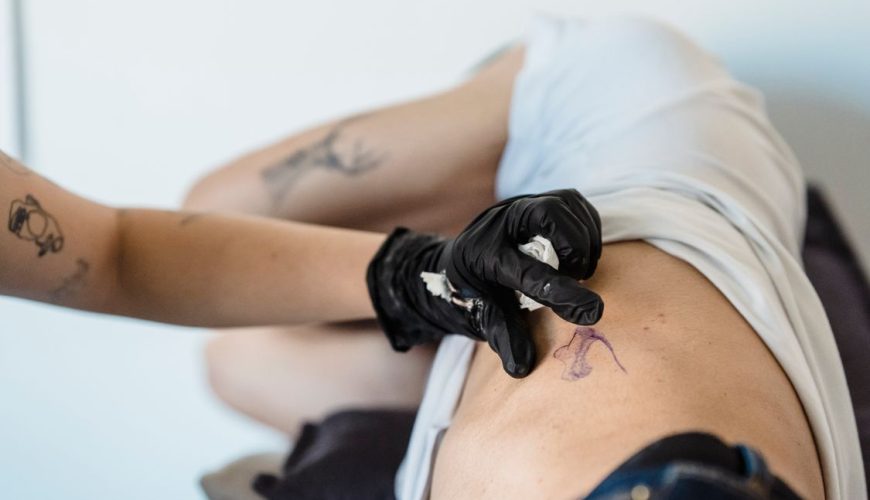 Tattoo artist working on a detailed design in a professional studio in Da Nang