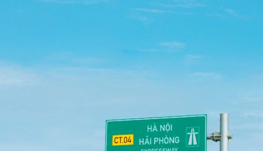 Expressway road sign against clear blue sky on a Vietnamese highway