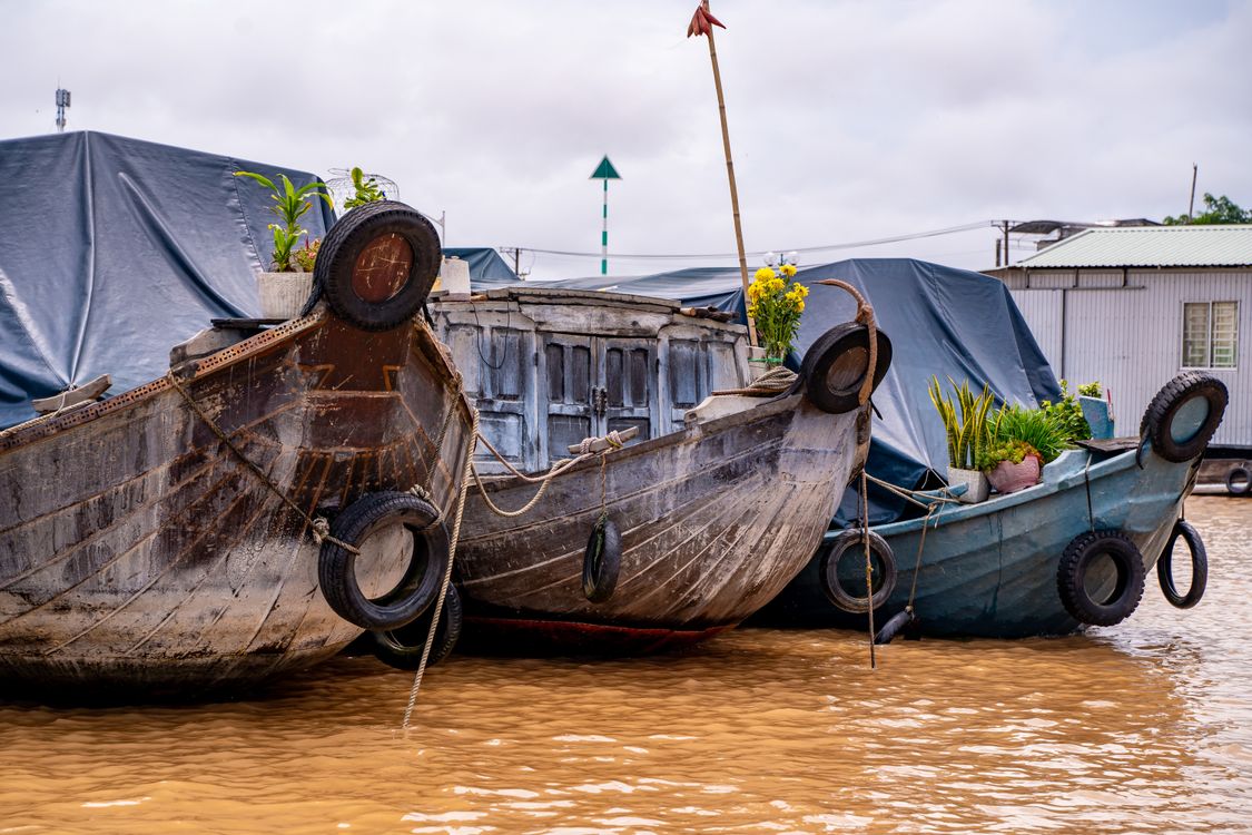 Traditional wooden boats loaded with fruit at a Mekong Delta floating market in Can Tho, Vietnam