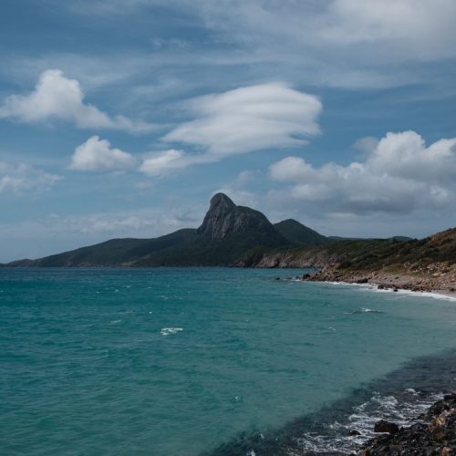 Con Dao island coastline — mountains rise straight out of the sea, one of 16 islands in Vietnam's Con Dao archipelago