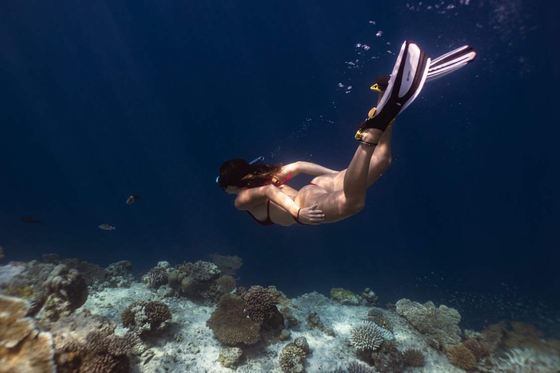 Snorkeler over a coral reef in clear water — Con Dao has some of Vietnam's best diving and snorkeling