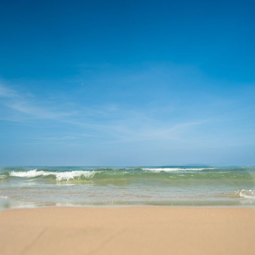 My Khe Beach in Da Nang, Vietnam - wide sandy beach with gentle waves and clear sky