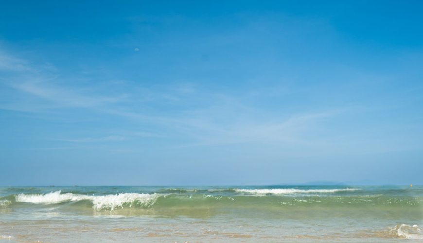 My Khe Beach in Da Nang, Vietnam - wide sandy beach with gentle waves and clear sky