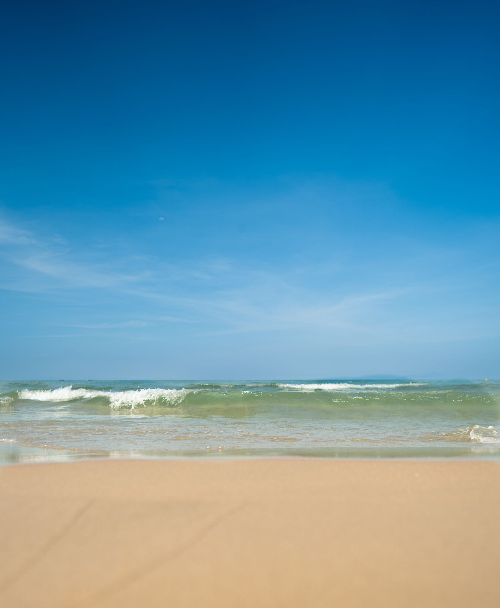 My Khe Beach in Da Nang, Vietnam - wide sandy beach with gentle waves and clear sky