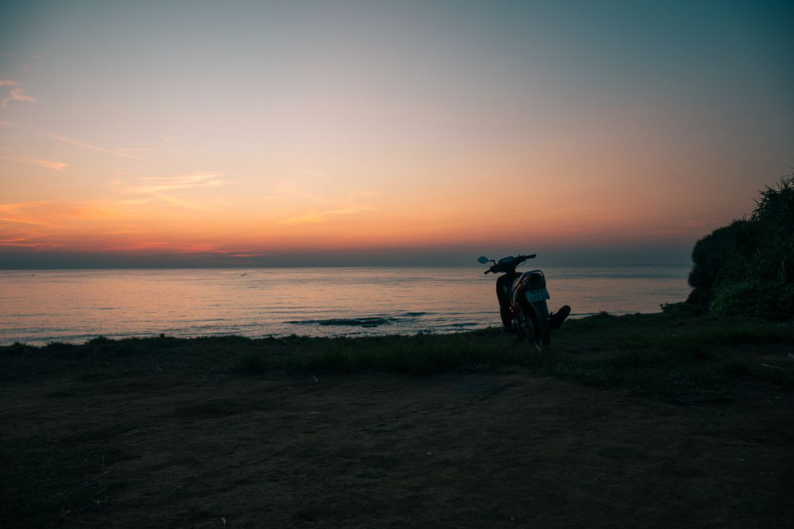 Vietnamese coastal road with a scooter beside the sea
