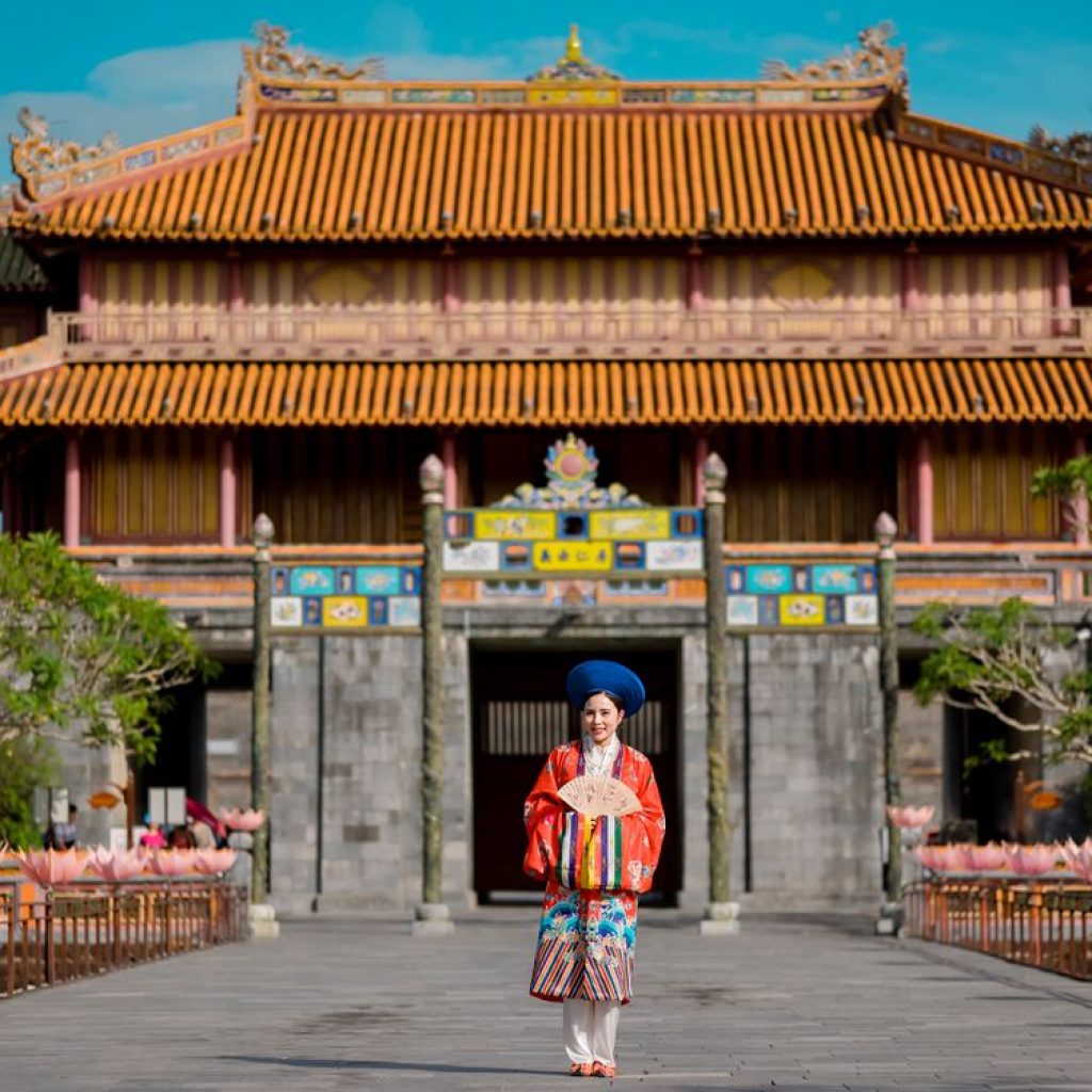 Woman wearing an ornate Nguyen-era court-style ceremonial robe