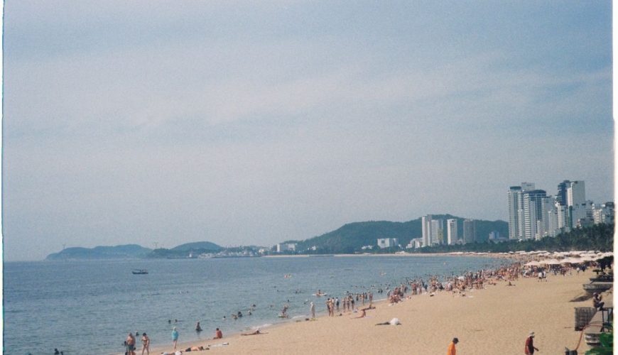 Summer day at Nha Trang Beach, Vietnam — the long city beach packed with people in the sun