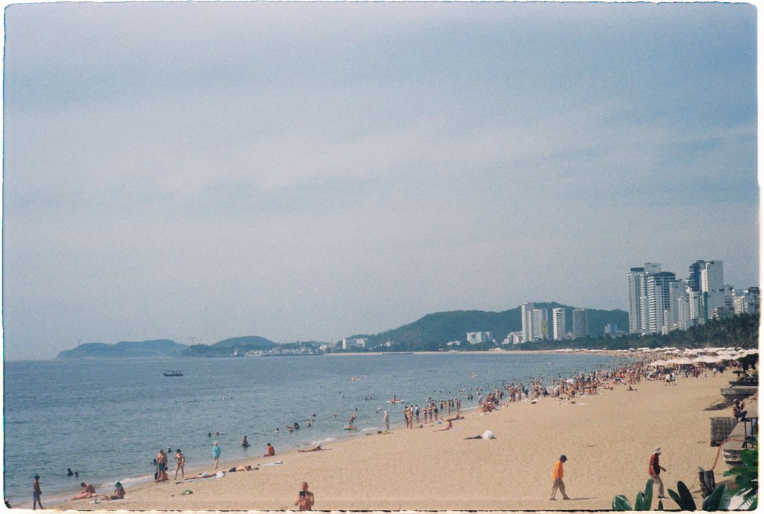 Summer day at Nha Trang Beach, Vietnam — the long city beach packed with people in the sun