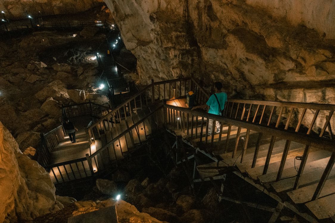 Illuminated wooden walkway and limestone stalactites inside Paradise Cave in Phong Nha-Ke Bang National Park