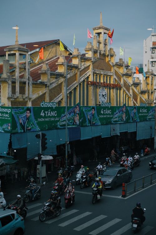 Motorbikes and cars on a busy central Saigon street near Ben Thanh Market