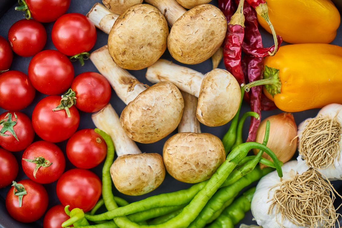 Plant-based meal with vegetables and herbs on a table