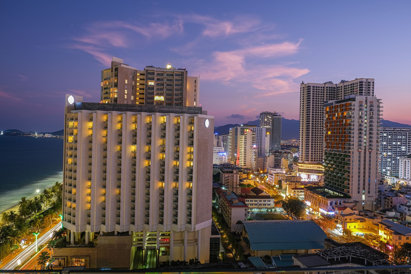 Illuminated buildings beside the sea in Nha Trang at twilight