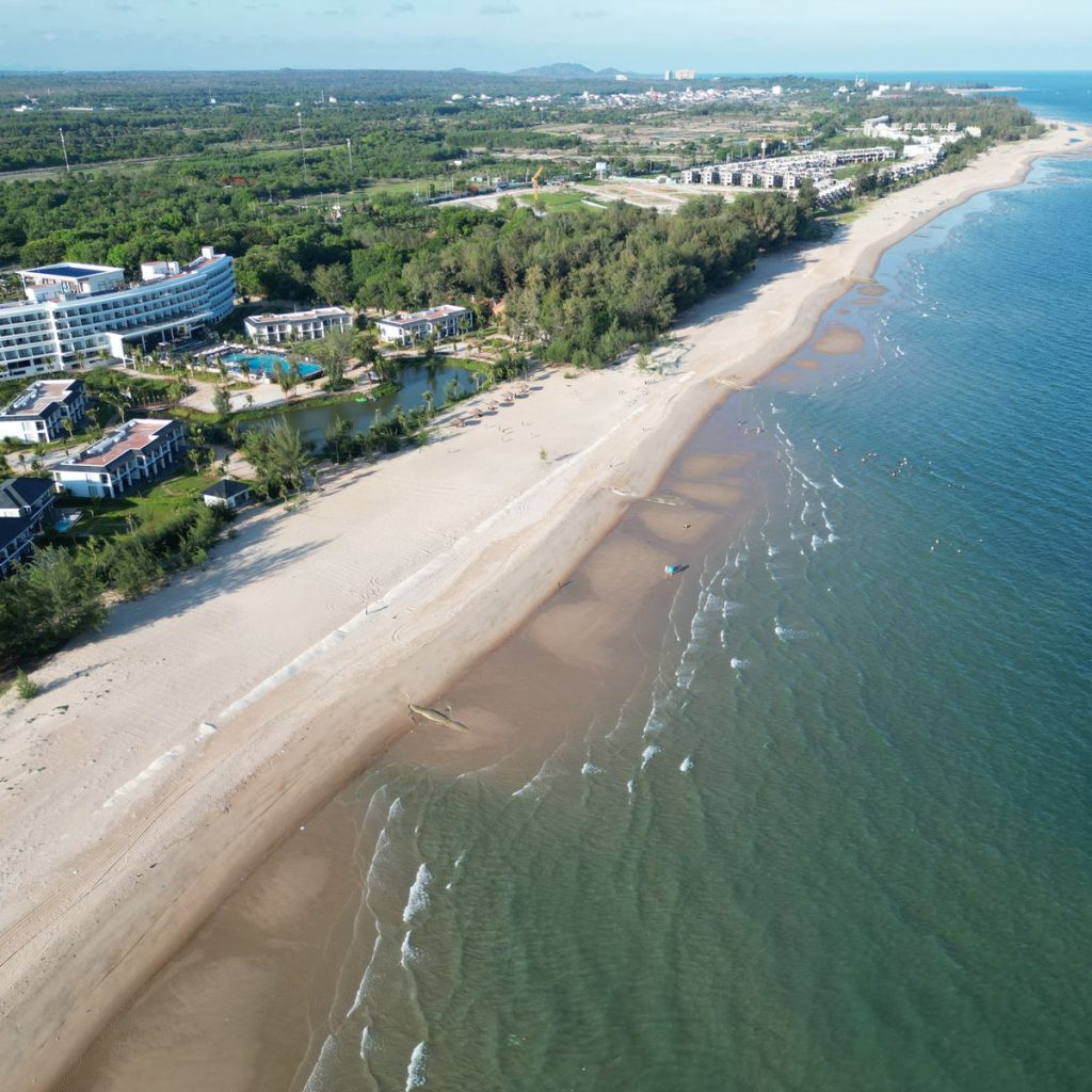 Aerial view of a luxury beachfront resort and sandy coastline in Ho Tram