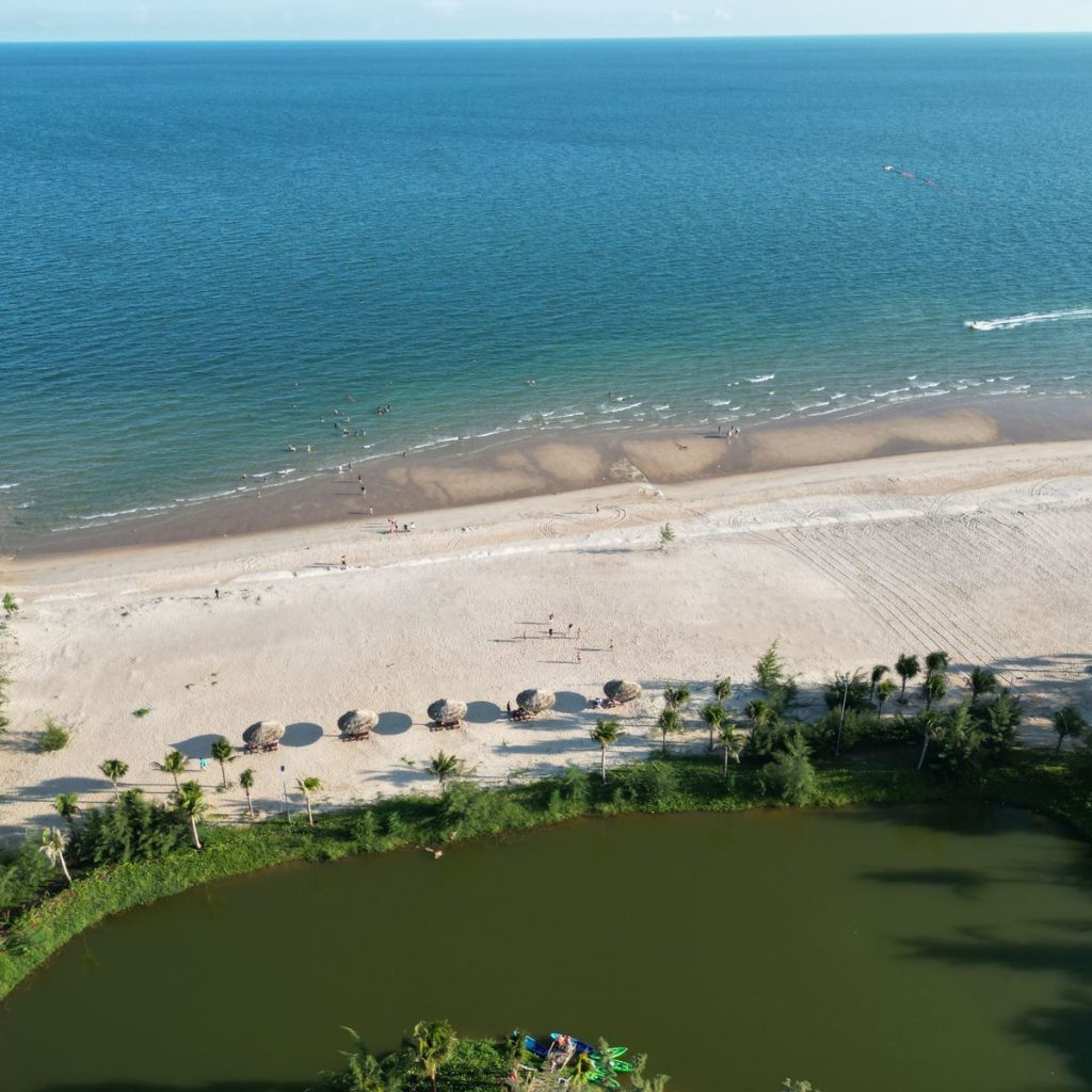 Aerial view of Ho Tram Beach with blue sea, sand and coastal greenery