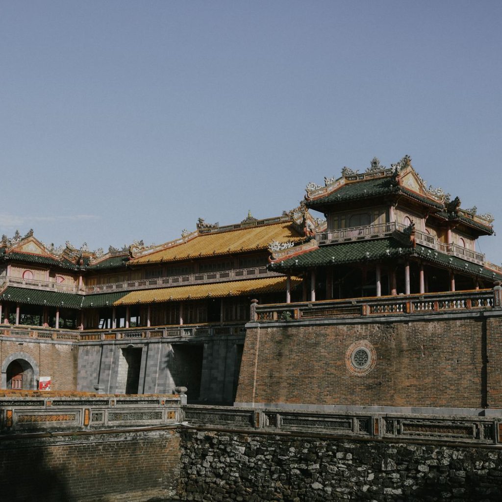 The Ngo Mon Meridian Gate of Hue's Imperial City, a grand walled citadel gateway topped with imperial yellow and green pavilions