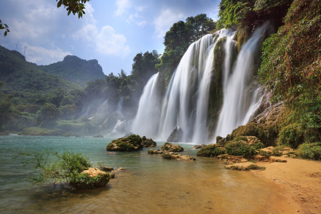 Ban Gioc Waterfall cascading below green hills in Cao Bang