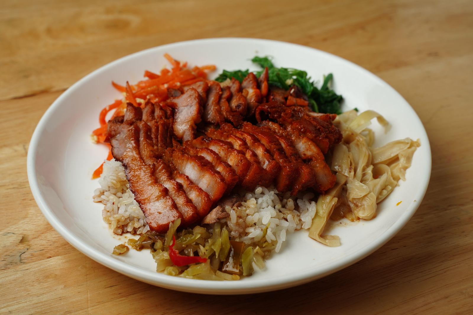 Grilled pork with rice, vegetables, and pickled toppings