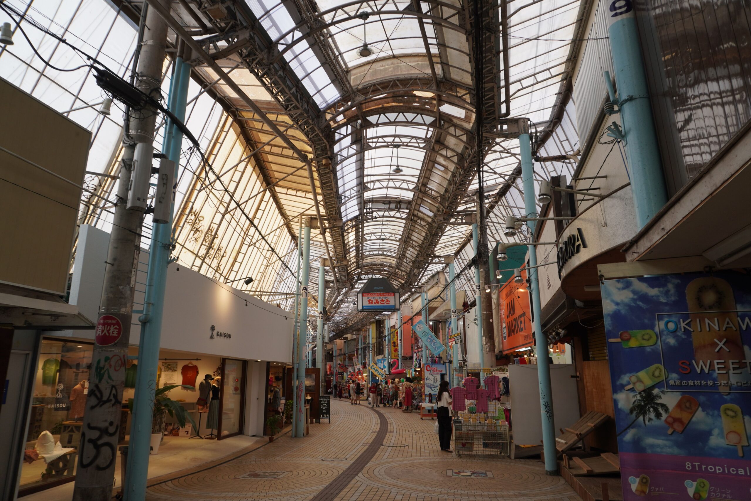 Covered market arcade and storefronts on Heiwa Dori Shopping Street in Naha.