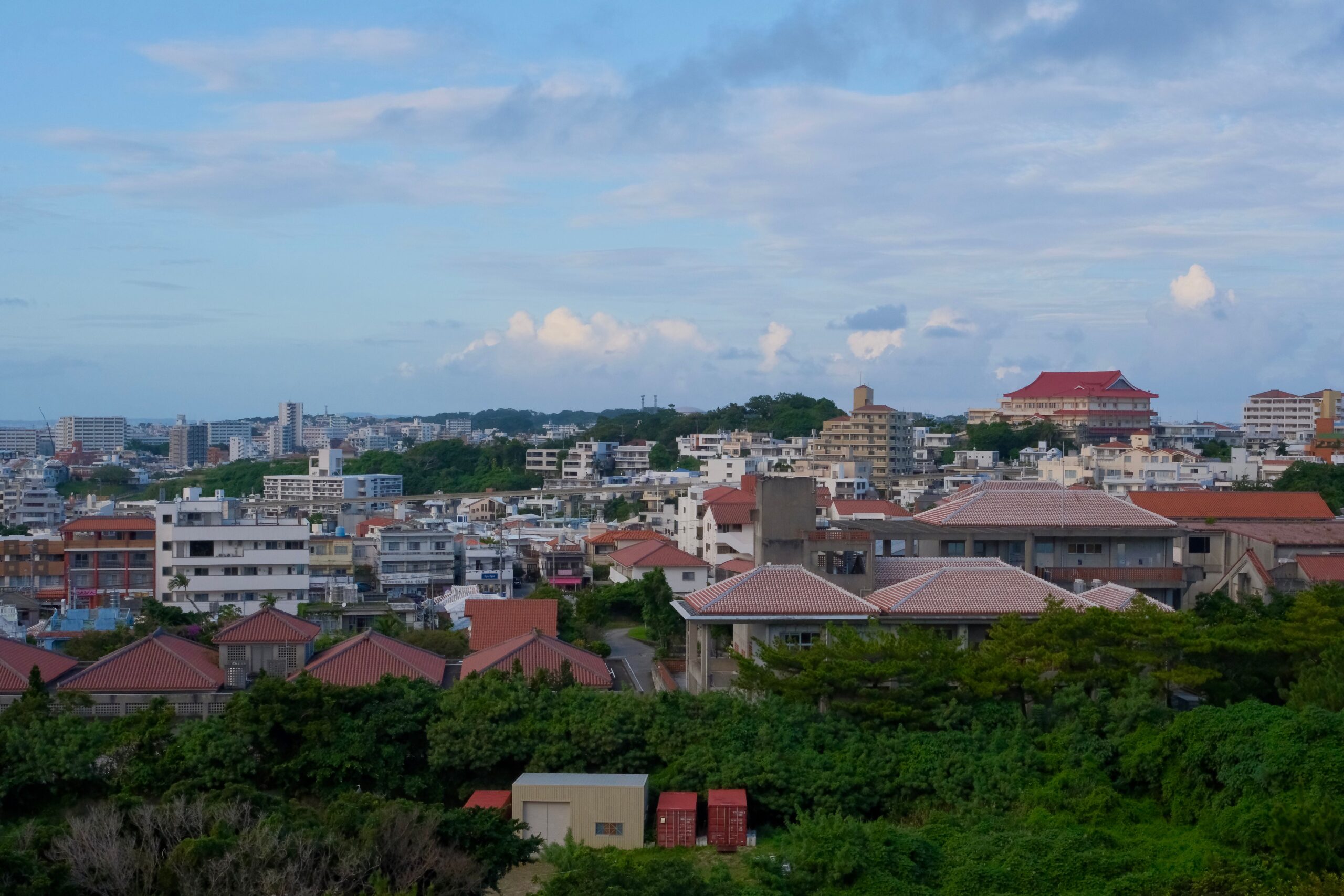 Panoramic view over Naha rooftops and city buildings in Okinawa.