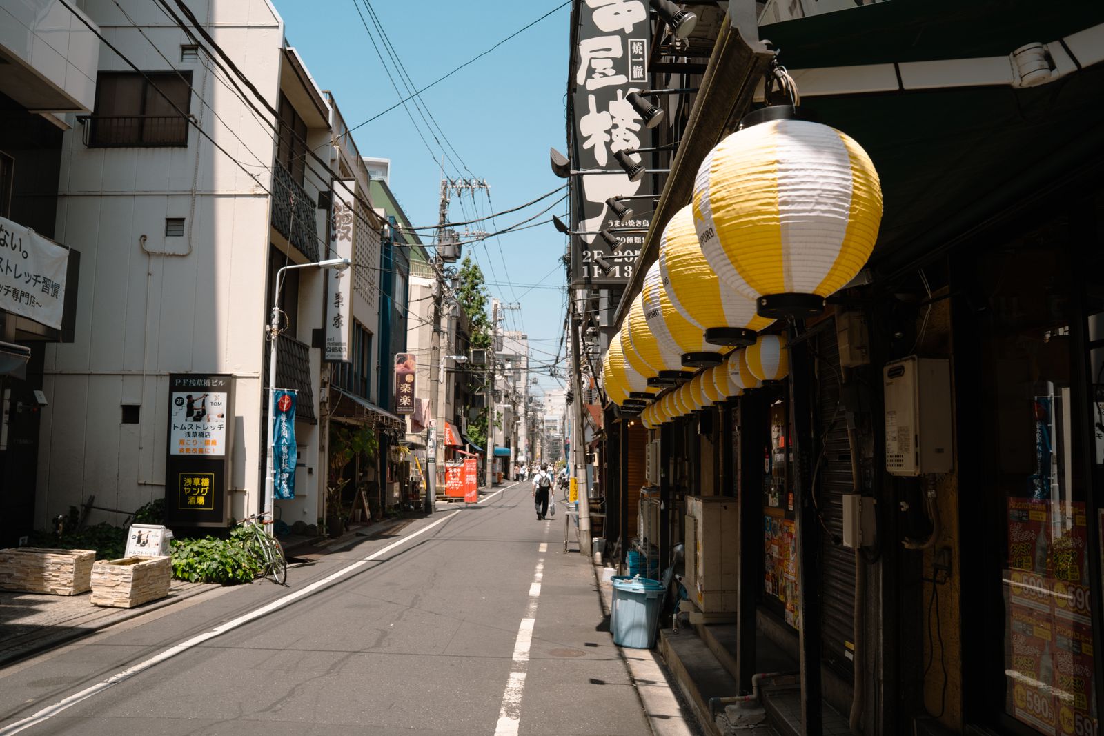 Lanterns beside small premises on a Tokyo street in daylight