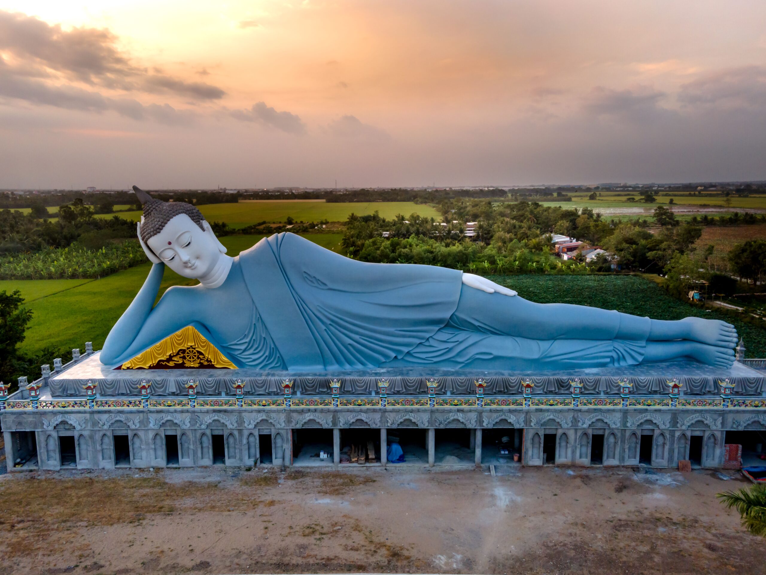 Reclining Buddha statue at Som Rong Pagoda in Sóc Trăng at sunset