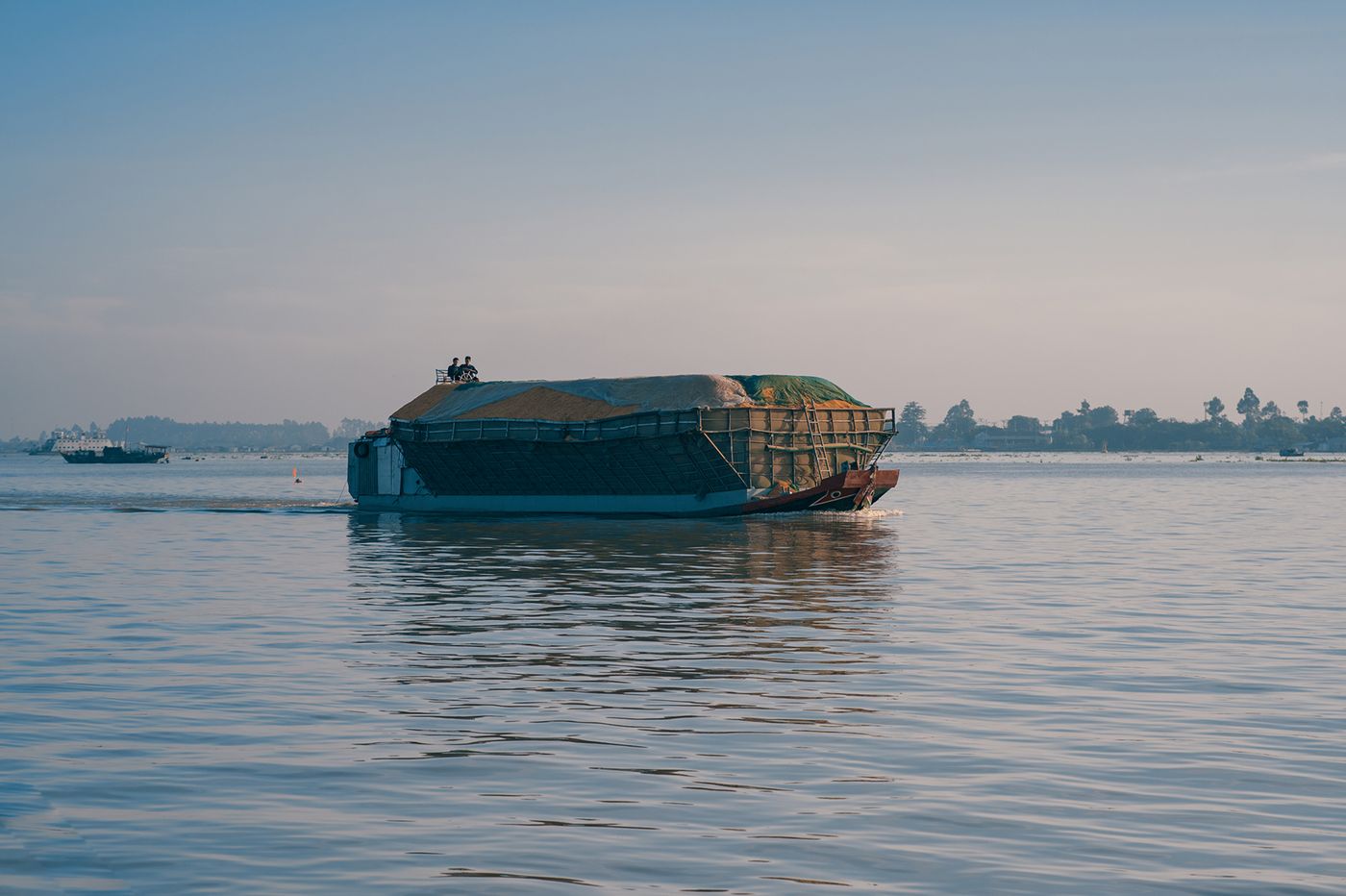 A cargo barge crosses the Mekong River near Sa Dec