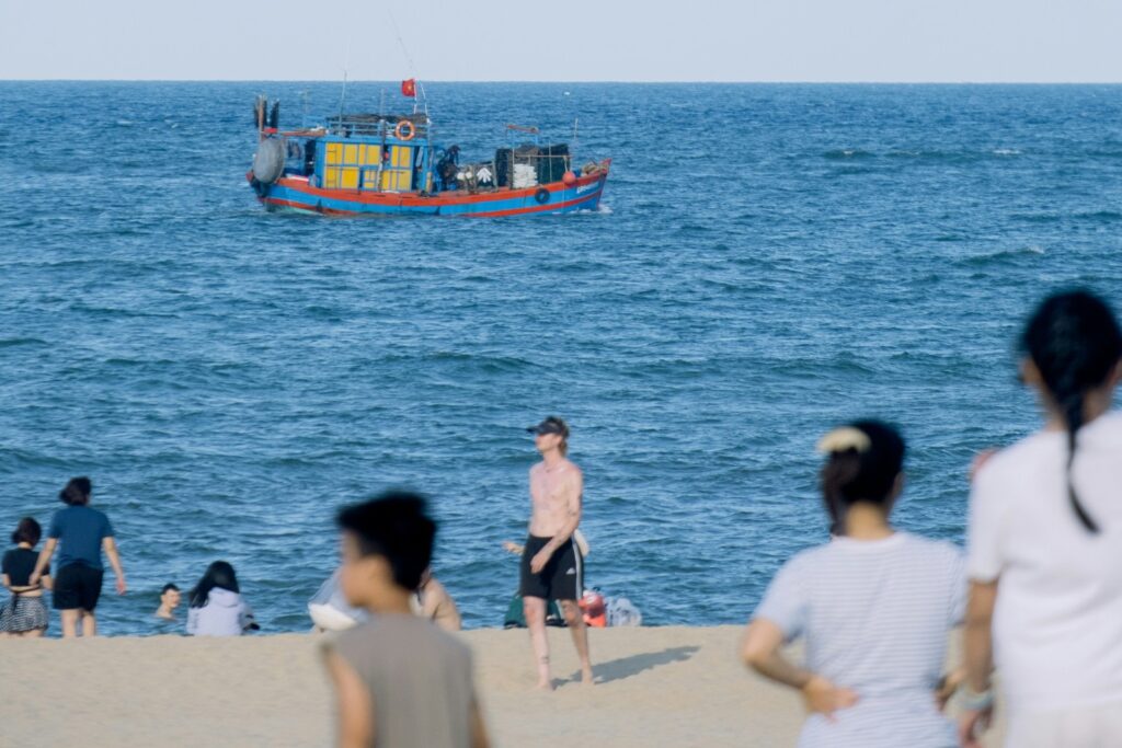 People beside the sea at Nhat Le Beach in Dong Hoi