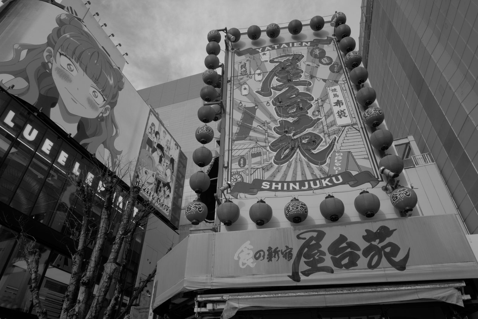 Black-and-white restaurant signs and building facades in Shinjuku