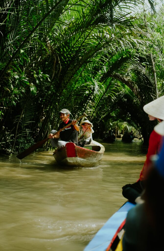 Canoe journey through a lush tropical waterway in Vietnam