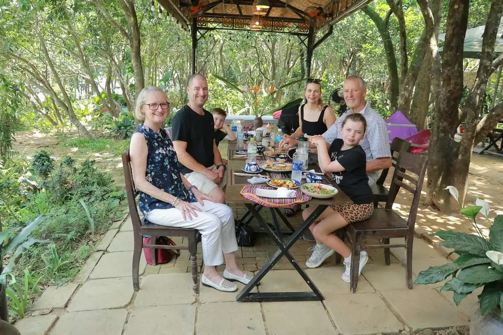 Guests enjoying the riverside garden cooking class in Hue