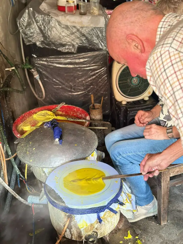 Making rice paper on a hot griddle in a Hue village
